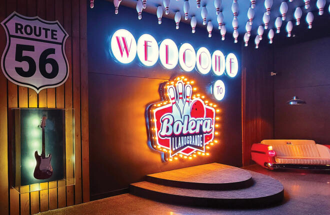 Lobby with center logo welcome sign and couch made from an antique car