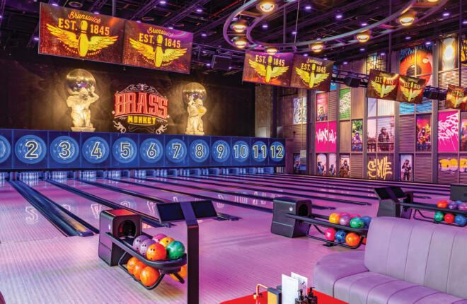 12 Brunswick bowling lanes colorfully lit. ball returns and sync scoring tablets
