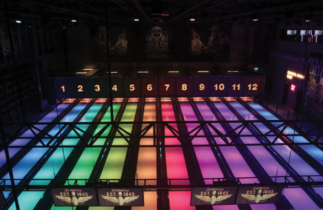 Top down image of bowling lane with multicolored lighting on each lane