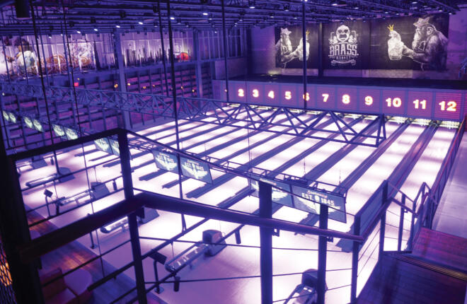 Top down image of the full bowling lanes, purple mood lighting
