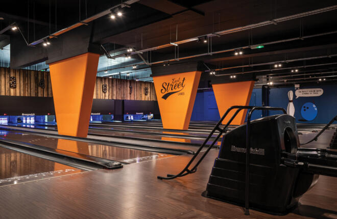 View of bowling lanes and ball returns