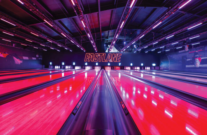 Vibrant pink bowling lanes with neon lighting