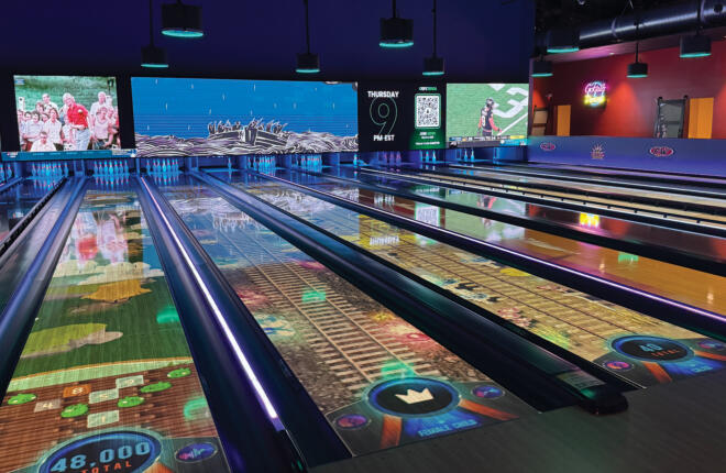 Bowling lanes at Fun Warehouse in Myrtle Beach, SC featuring Brunswick Sync animated lane graphics, an overhead video wall, and live trivia display
