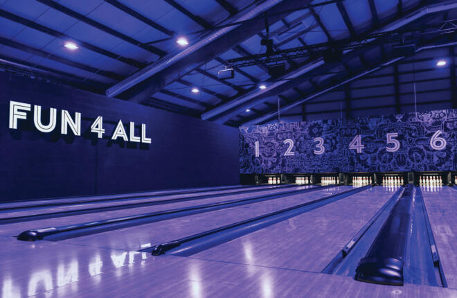 7 Brunswick bowling lanes with center name on wall in neon lights