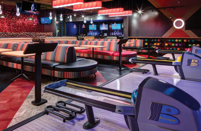 VIP bowlers area with center stage seating, sync tablets, and ball returns