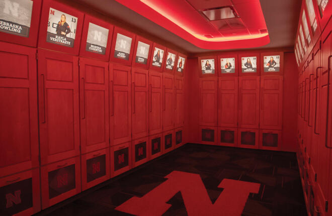 Locker area for bowlers bathed in the school color lighting. (Red) l