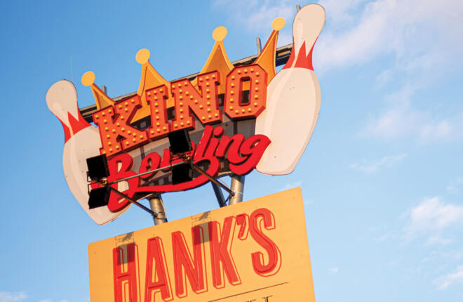 Dimensional building signage with lighted typography, crowns and bowling pins