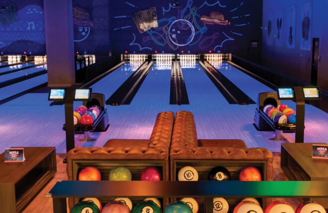 Bowlers area, tufted couches, Sync tablets looking down lane at the pins