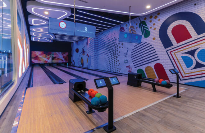 Bowling lanes with digital screens showing player feedback