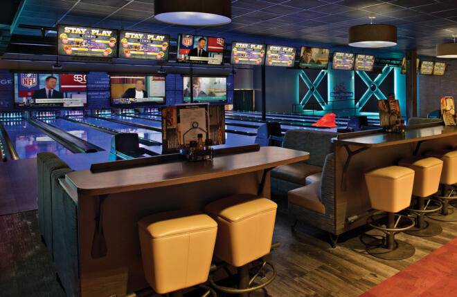 Down lane view of the bowling lanes, seating in foreground