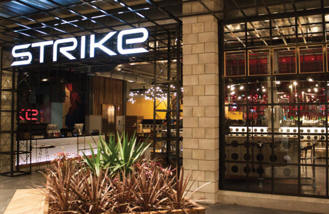 Main entrance with lite "SRIKE" signage hung over the door