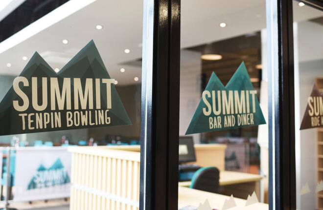 Summit logo decal mounted on glass door ways