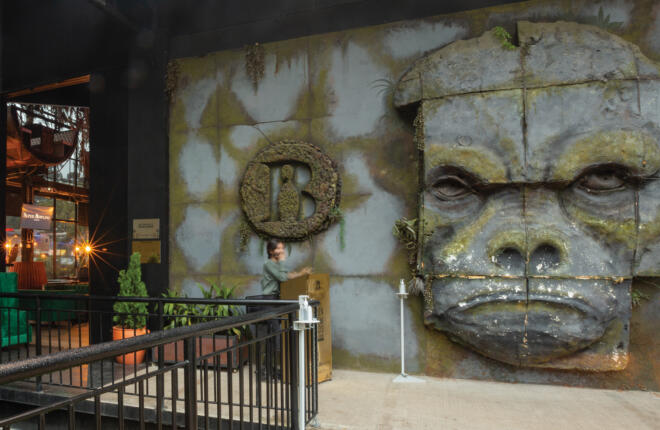 Center entrance with a large sculpted gorilla face protruding from the wall