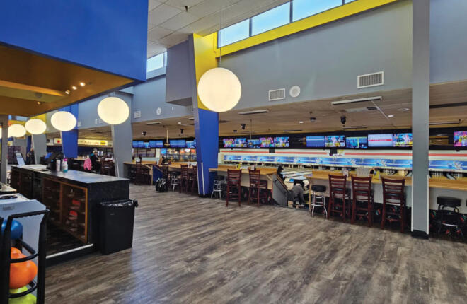 Bowling lanes, lounge seating, and bar area with pendant lighting at Tenpins & More bowling center in Rio Rancho, New Mexico.