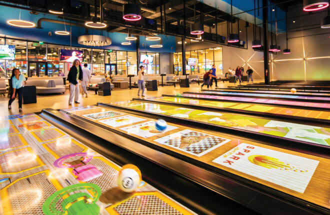 People bowling on lanes