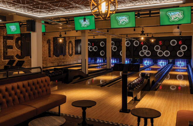 Upscale bowling venue with green Vintner Lanes screens and leather seating.