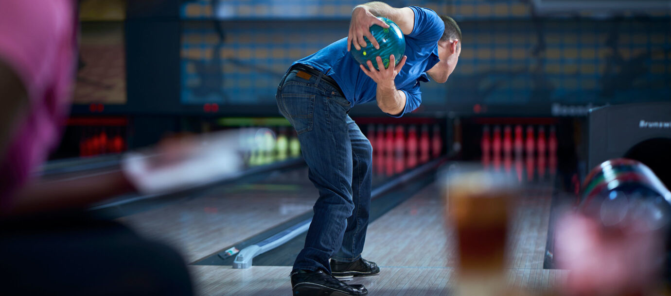 View from behind two-handed bowler at upswing