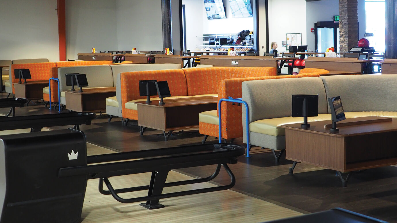 Brunswick bowling ball returns with coffee table and rounded booth seating